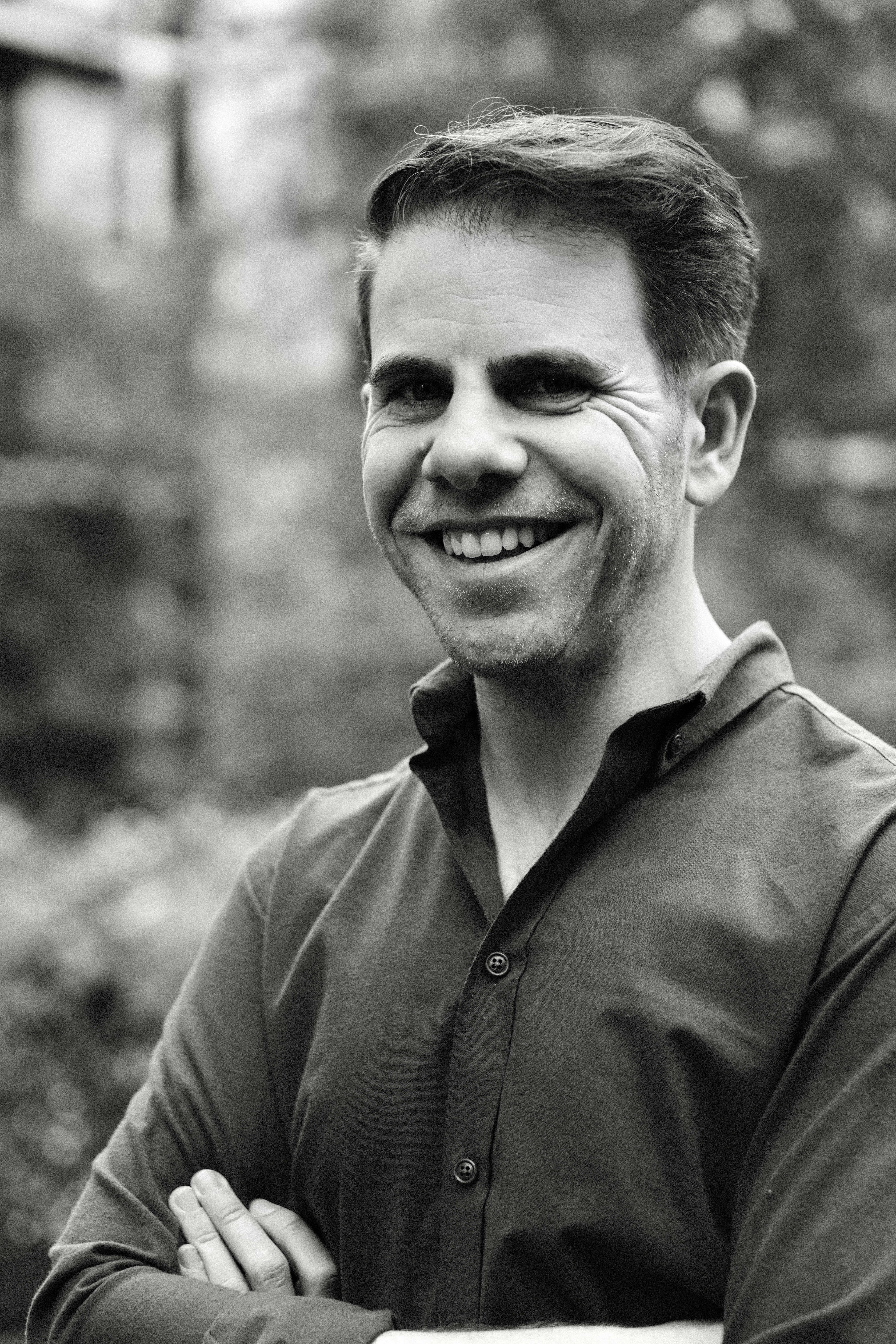 Daniel Schwarz, CompetitionAI co-founder in competition law — portrait outdoors, arms crossed
